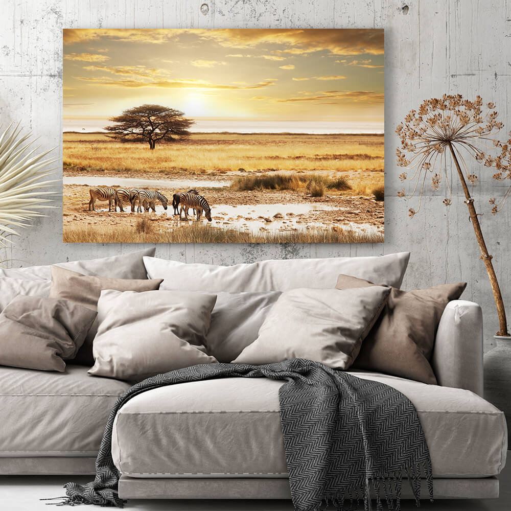 Rechteckiges Akustikbild einer Savannenlandschaft mit Zebras in goldenem Licht, über einem Sofa